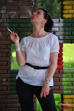 Brunette babe smoking against the wall - N