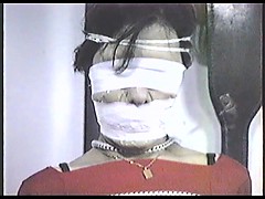 Poletied and tightly tape gagged
